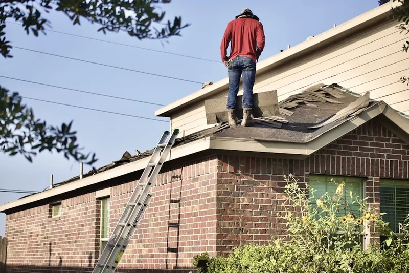 Professional roofer working on a residential roof in Ackermanville